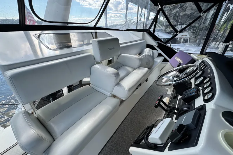 Slide: The Image of Interior of 1996 Silverton 372 Motor Yacht with helm and seating area. - 12