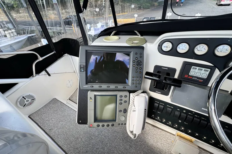 Slide: The Image of 1996 Silverton 372 Motor Yacht helm with navigation equipment and control panel. - 13