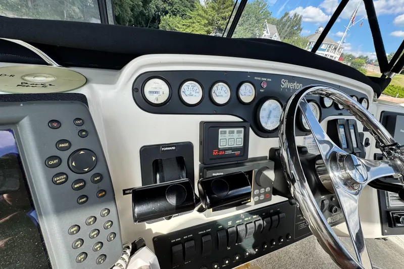 Slide: The Image of 1996 Silverton 372 Motor Yacht dashboard with steering wheel and control panel. - 14