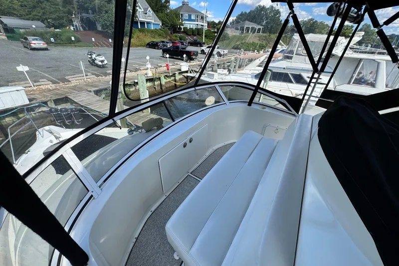 Slide: The Image of 1996 Silverton 372 Motor Yacht interior with dockside view and seating area. - 18