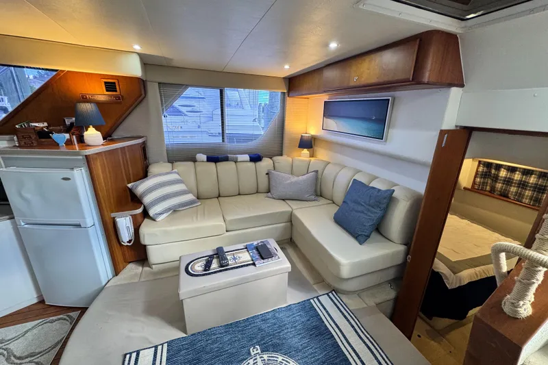 Slide: The Image of Interior of a 1996 Silverton 372 Motor Yacht with cozy seating and nautical decor. - 22