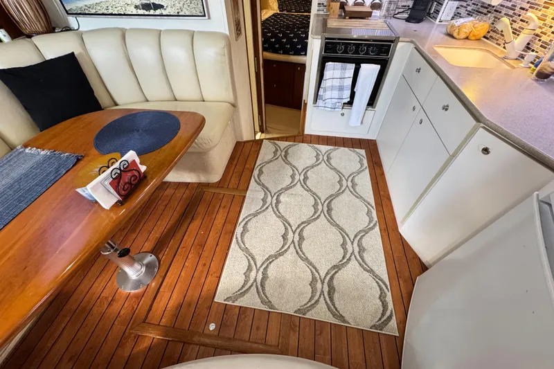 Slide: The Image of Interior of 1996 Silverton 372 Motor Yacht with dining area and kitchen. - 26
