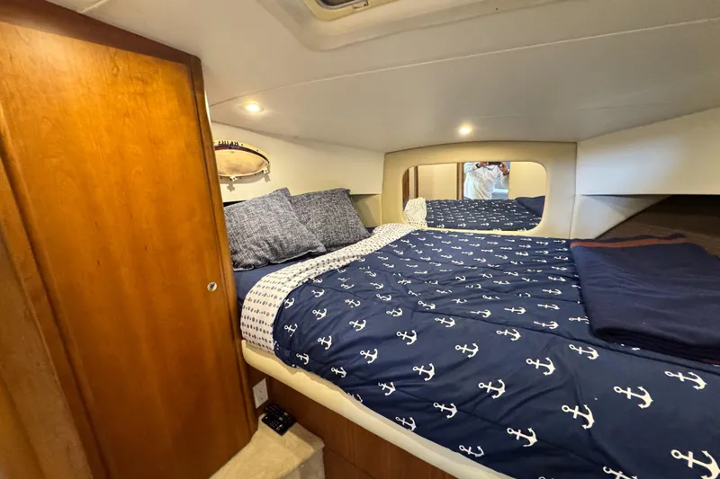 Slide: The Image of Cozy bedroom in 1996 Silverton 372 Motor Yacht with nautical-themed bedding. - 30