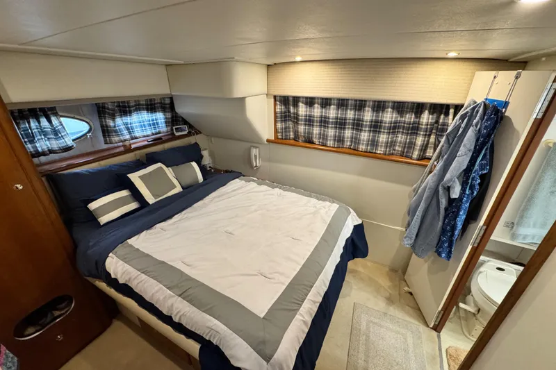 Slide: The Image of Cozy bedroom in 1996 Silverton 372 Motor Yacht with plaid curtains and modern bedding. - 34