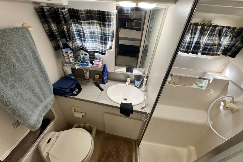 Slide: The Image of Bathroom interior of 1996 Silverton 372 Motor Yacht with sink, shower, and toiletries. - 37