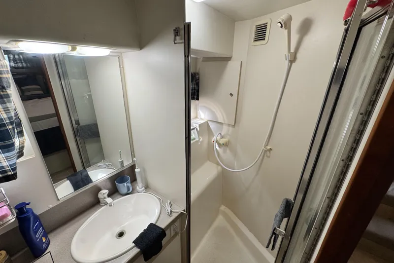 Slide: The Image of Bathroom interior of 1996 Silverton 372 Motor Yacht with sink and shower. - 38