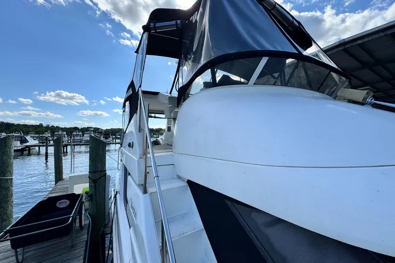 Slide: The Image of 1996 Silverton 372 Motor Yacht docked under a clear blue sky. - 5
