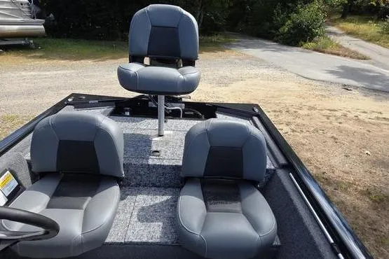 Slide: The Image of 2026 Tracker Pro 170 boat interior with three gray seats on a textured deck. - 12