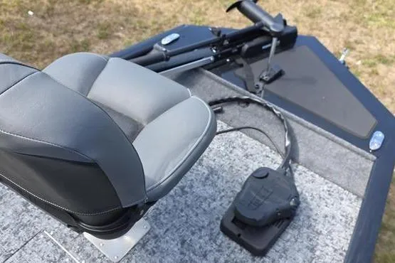 Slide: The Image of 2026 Tracker Pro 170 boat interior with gray seat and foot pedal on carpeted deck. - 5