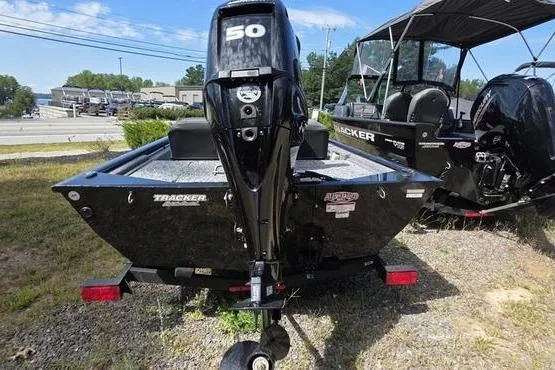 Slide: The Image of 2026 Tracker Pro 170 boat with 50 HP engine, parked outdoors on grass. - 6