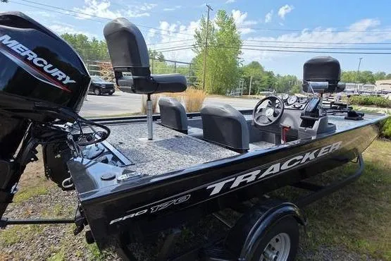 Slide: The Image of 2026 Tracker Pro 170 boat with Mercury engine, parked outdoors on a sunny day. - 7