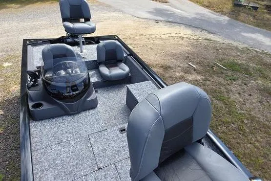 Slide: The Image of 2026 Tracker Pro 170 boat interior with gray seating and steering console. - 8