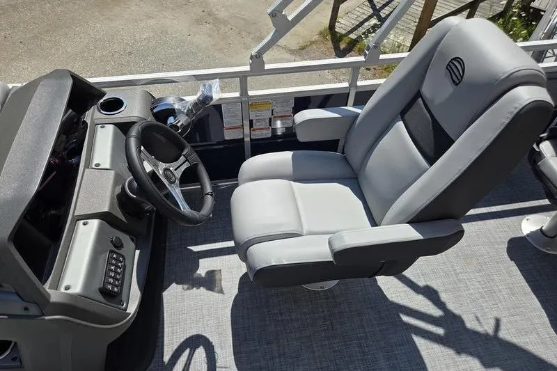 Slide: The Image of 2026 Sun Tracker SF 20 DLX boat interior with steering wheel and comfortable seating. - 11