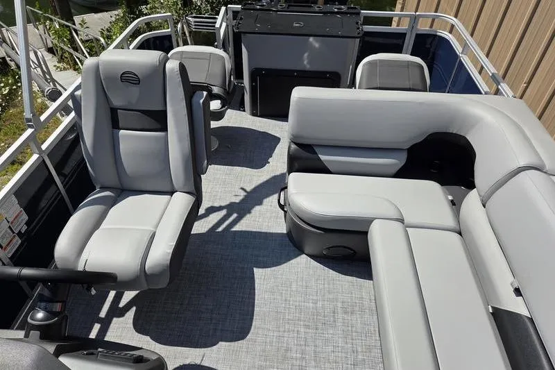 Slide: The Image of 2026 Sun Tracker SF 20 DLX pontoon boat interior with gray seating and helm. - 14