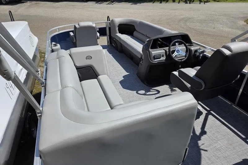 Slide: The Image of 2026 Sun Tracker SF 20 DLX pontoon boat interior with gray seating and steering console. - 17