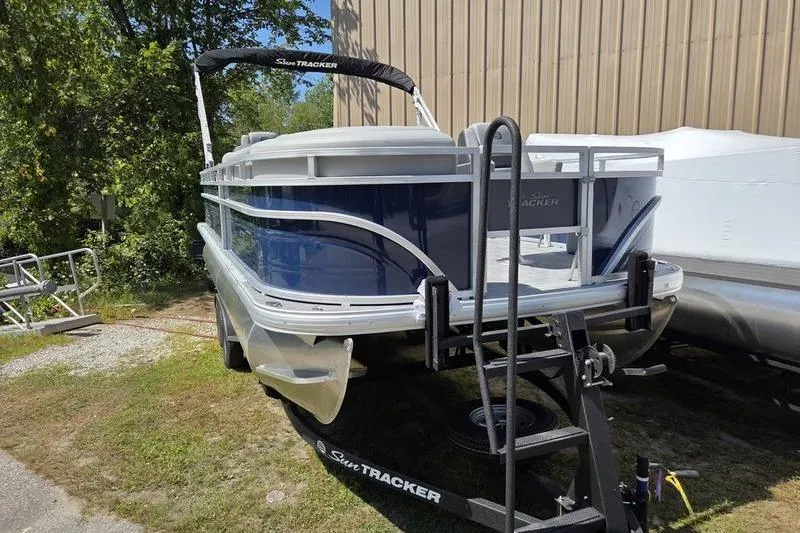 Slide: The Image of 2026 Sun Tracker SF 20 DLX pontoon boat on trailer, parked outdoors. - 5