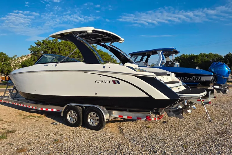 Slide: The Image of 2023 Cobalt R30 boat on trailer, parked outdoors under a clear blue sky. - 15