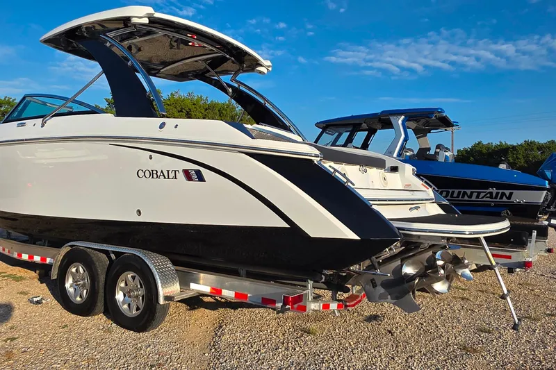 Slide: The Image of 2023 Cobalt R30 boat on trailer under clear blue sky. - 16