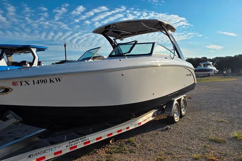 Slide: The Image of 2023 Cobalt R30 boat on trailer under clear blue sky. - 17