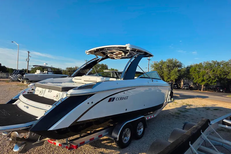 Slide: The Image of 2023 Cobalt R30 boat on trailer under clear blue sky. - 19