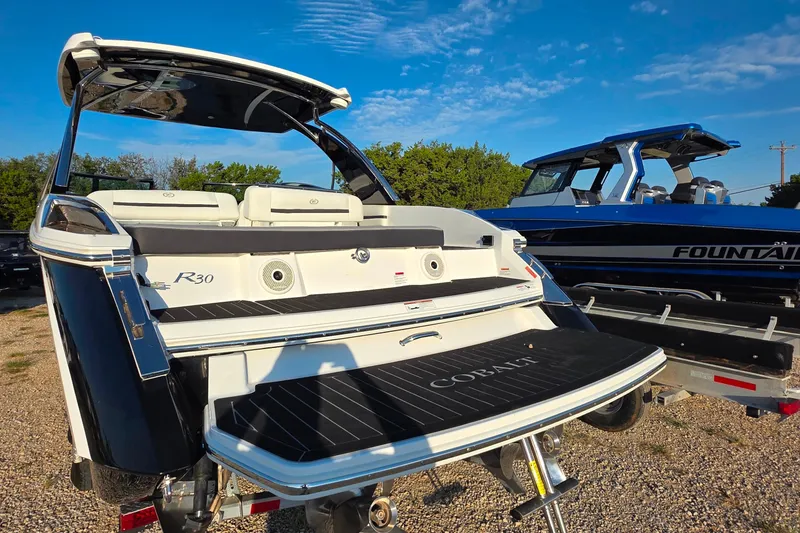 Slide: The Image of 2023 Cobalt R30 boat with sleek design, parked outdoors under a clear blue sky. - 20