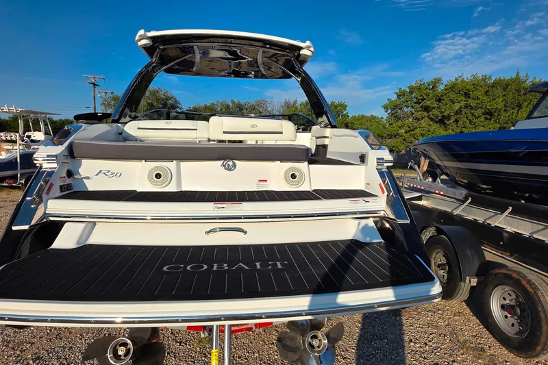 Slide: The Image of 2023 Cobalt R30 boat rear view with sleek design and spacious seating. - 21