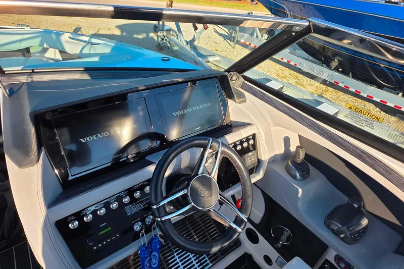 Slide: The Image of 2023 Cobalt R30 boat dashboard with Volvo Penta displays and steering wheel. - 28