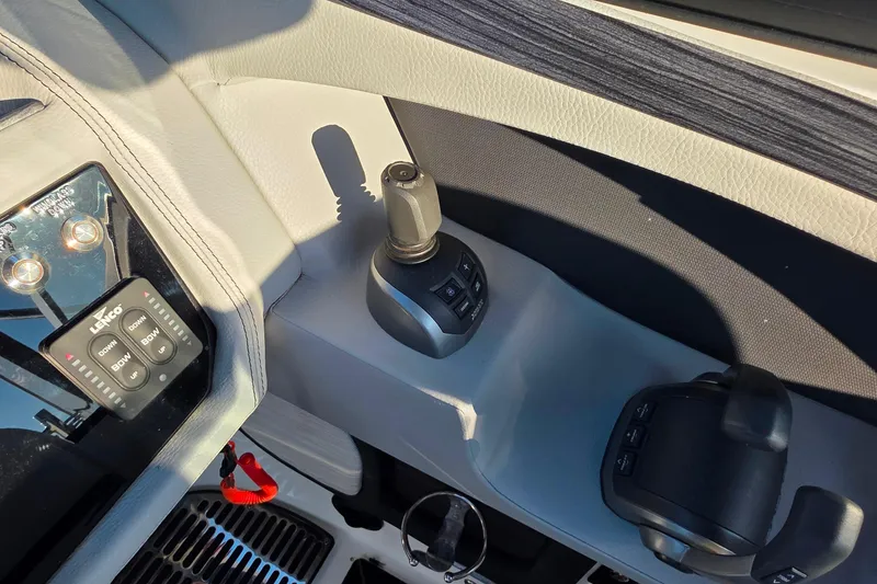 Slide: The Image of 2023 Cobalt R30 boat control panel with joystick and Lenco trim tab switches. - 29