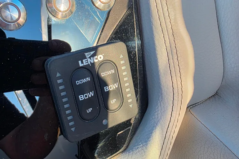 Slide: The Image of Lenco control panel on 2023 Cobalt R30 boat, featuring bow adjustment buttons. - 35