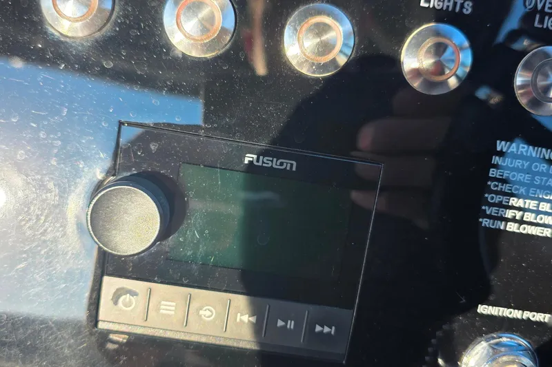 Slide: The Image of 2023 Cobalt R30 boat dashboard with Fusion audio system and control buttons. - 36