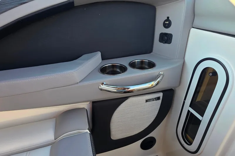 Slide: The Image of 2023 Cobalt R30 boat interior with cup holders and Harman Kardon speaker. - 41