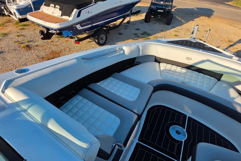 Slide: The Image of 2023 Cobalt R30 boat interior with white cushioned seating and sleek design. - 44