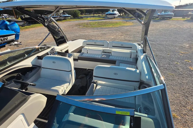 Slide: The Image of 2023 Cobalt R30 boat interior with white seating and open deck design. - 48