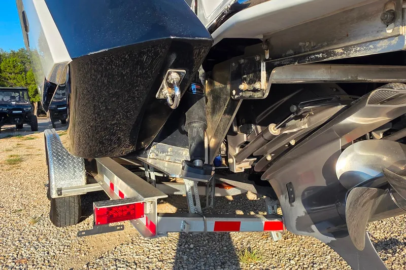Slide: The Image of 2023 Cobalt R30 boat on trailer, showing propeller and rear details. - 55