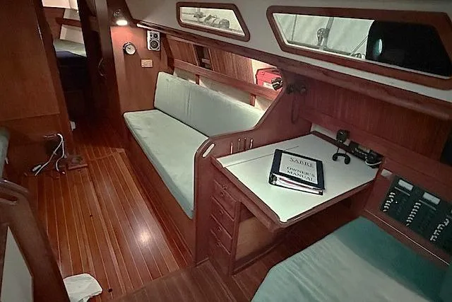 Slide: The Image of Interior of 1985 Sabre 36 sailboat with wooden furnishings and seating area. - 12