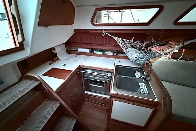 Slide: The Image of Interior of 1985 Sabre 36 sailboat galley with stove, sink, and storage. - 14