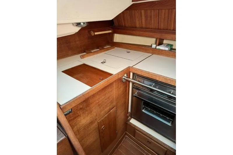 Slide: The Image of 1985 Sabre 36 yacht kitchen with wood cabinetry and built-in oven. - 15
