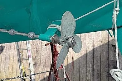 Slide: The Image of 1985 Sabre 36 sailboat propeller with ropes, docked near wooden fence. - 22