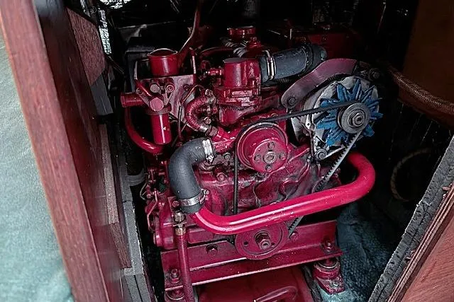 Slide: The Image of Engine of a 1985 Sabre 36 sailboat, featuring red components and visible piping. - 24