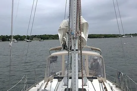 Slide: The Image of 1985 Sabre 36 sailboat on calm waters with overcast sky. - 3