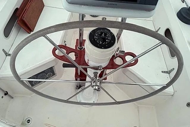 Slide: The Image of Steering wheel and compass of a 1985 Sabre 36 sailboat cockpit. - 6