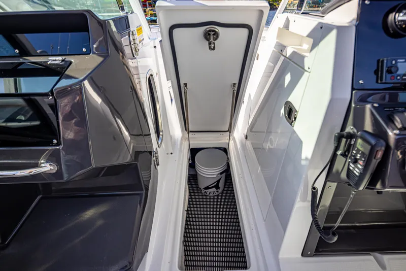 Slide: The Image of 2021 Blackfin 252DC boat interior with storage compartment and marine equipment. - 22