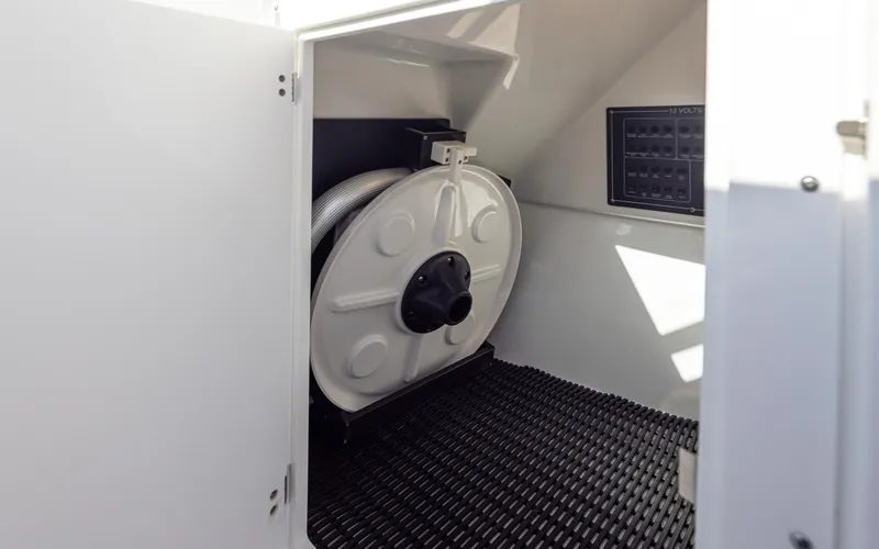 Slide: The Image of 2021 Blackfin 252DC storage compartment with hose reel and textured flooring. - 23