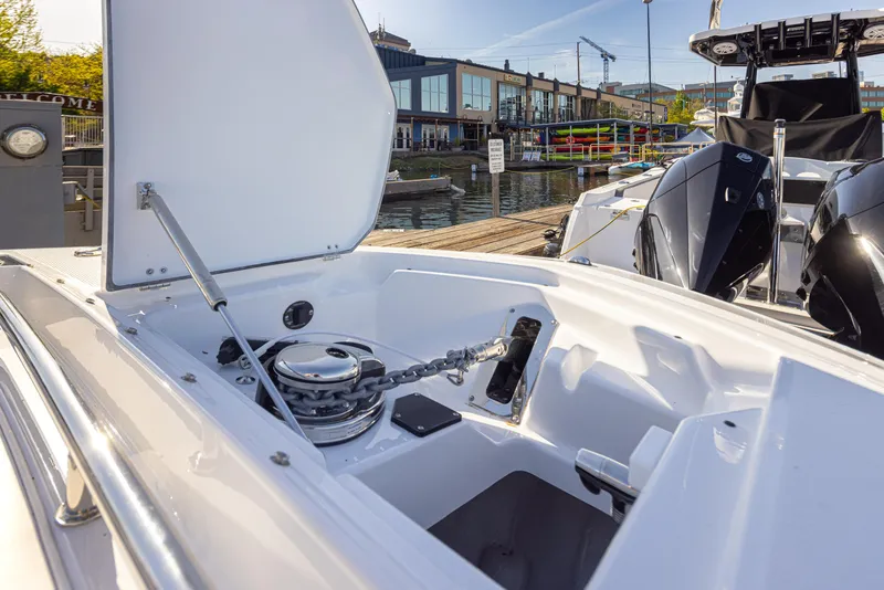 Slide: The Image of 2021 Blackfin 252DC boat anchor compartment open at marina. - 24