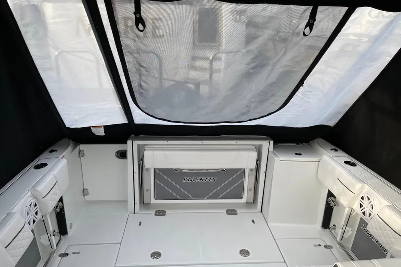 Slide: The Image of 2021 Blackfin 252DC boat interior with seating and storage compartments. - 28