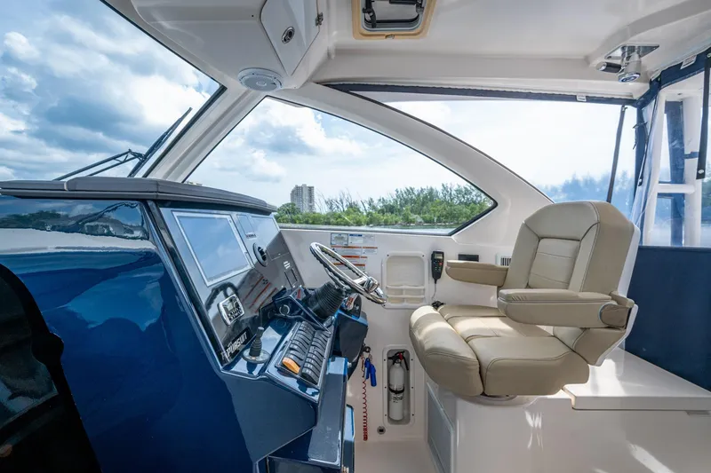 Slide: The Image of Luxurious Pursuit boat cockpit with leather captain's chair and modern control panel. - 21