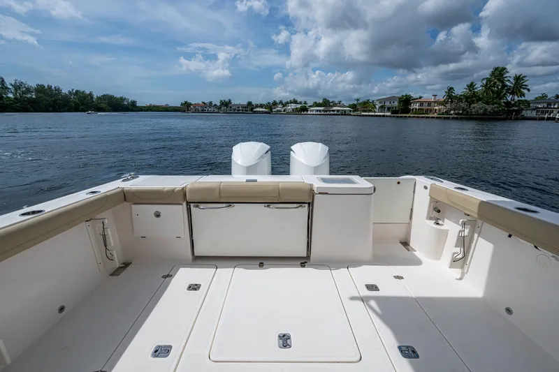 Slide: The Image of Spacious deck of a Pursuit boat overlooking calm waters and distant shoreline. - 28
