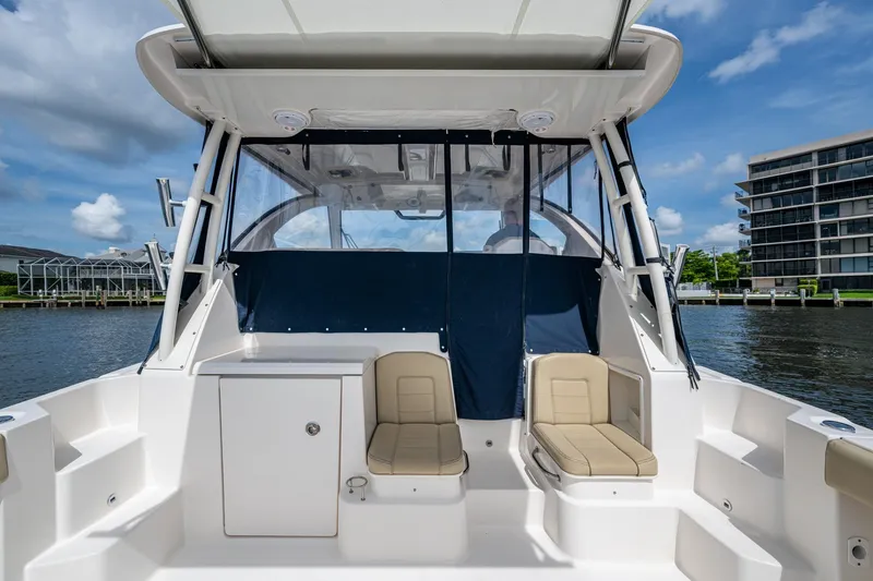 Slide: The Image of Pursuit boat interior with seating, dockside view, and clear blue sky. - 38