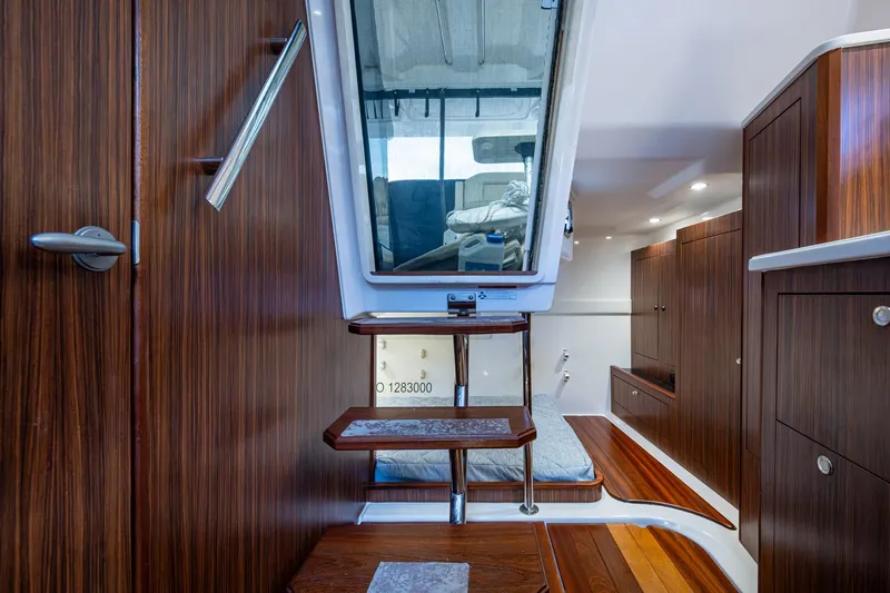 Slide: The Image of Luxurious Pursuit boat interior with wooden cabinetry and modern design. - 42