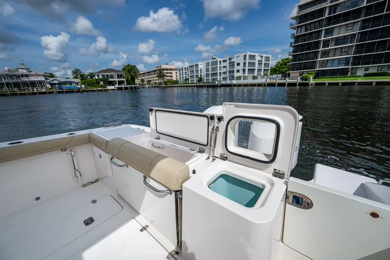 Slide: The Image of Pursuit boat interior with open storage, dockside view, and modern waterfront buildings. - 47